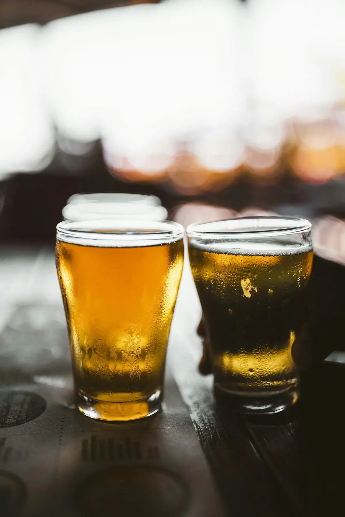 Two glasses of beer at sunset